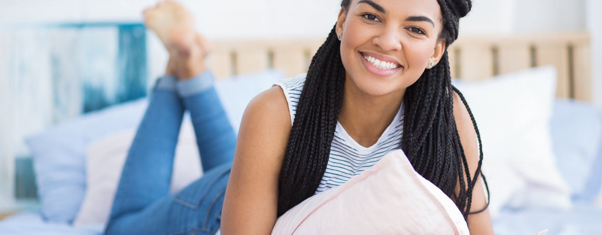 happy-young-african-american-woman-resting-bed-min.jpg